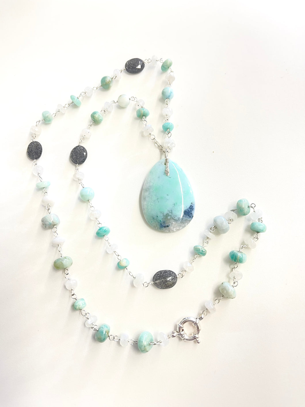Necklace with baby blue colors opalized wood