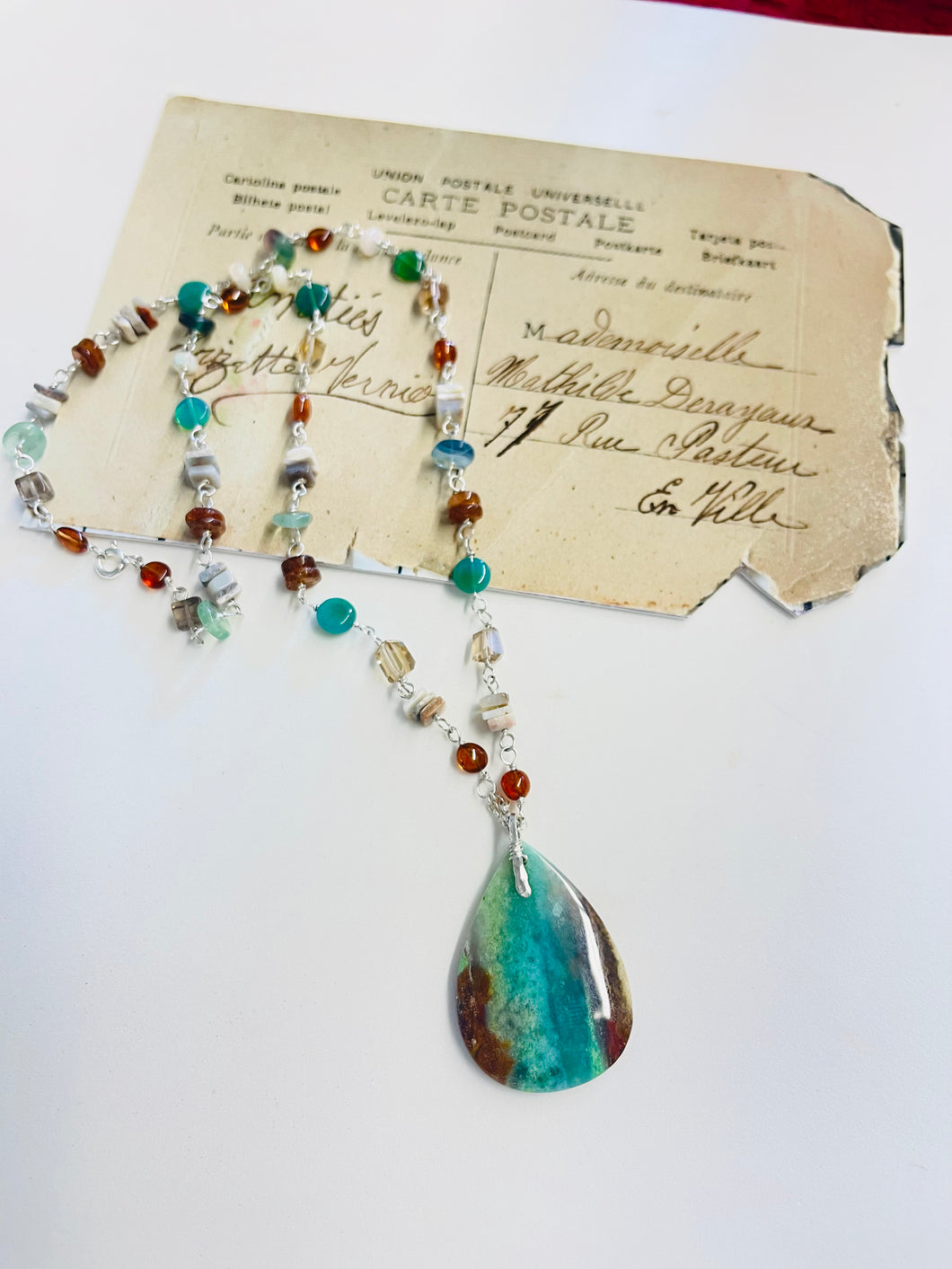 Necklace with multi color petrified opalized wood