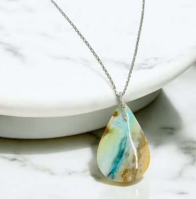 Pendant with light blue colors petrified opalized wood