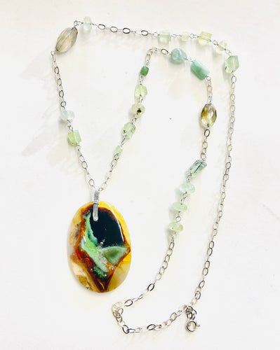 Necklace with peacock colors on petrified opalized wood