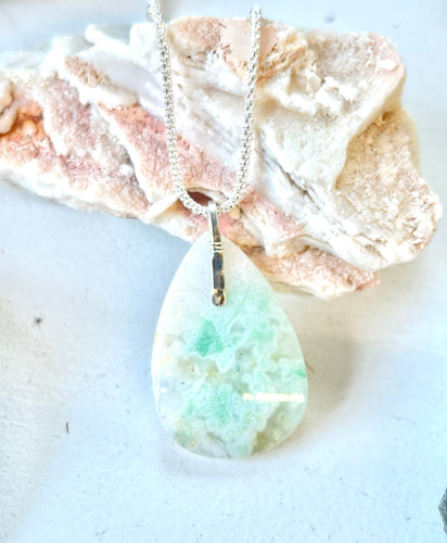 Pendant - long- with light blue colors petrified opalized wood