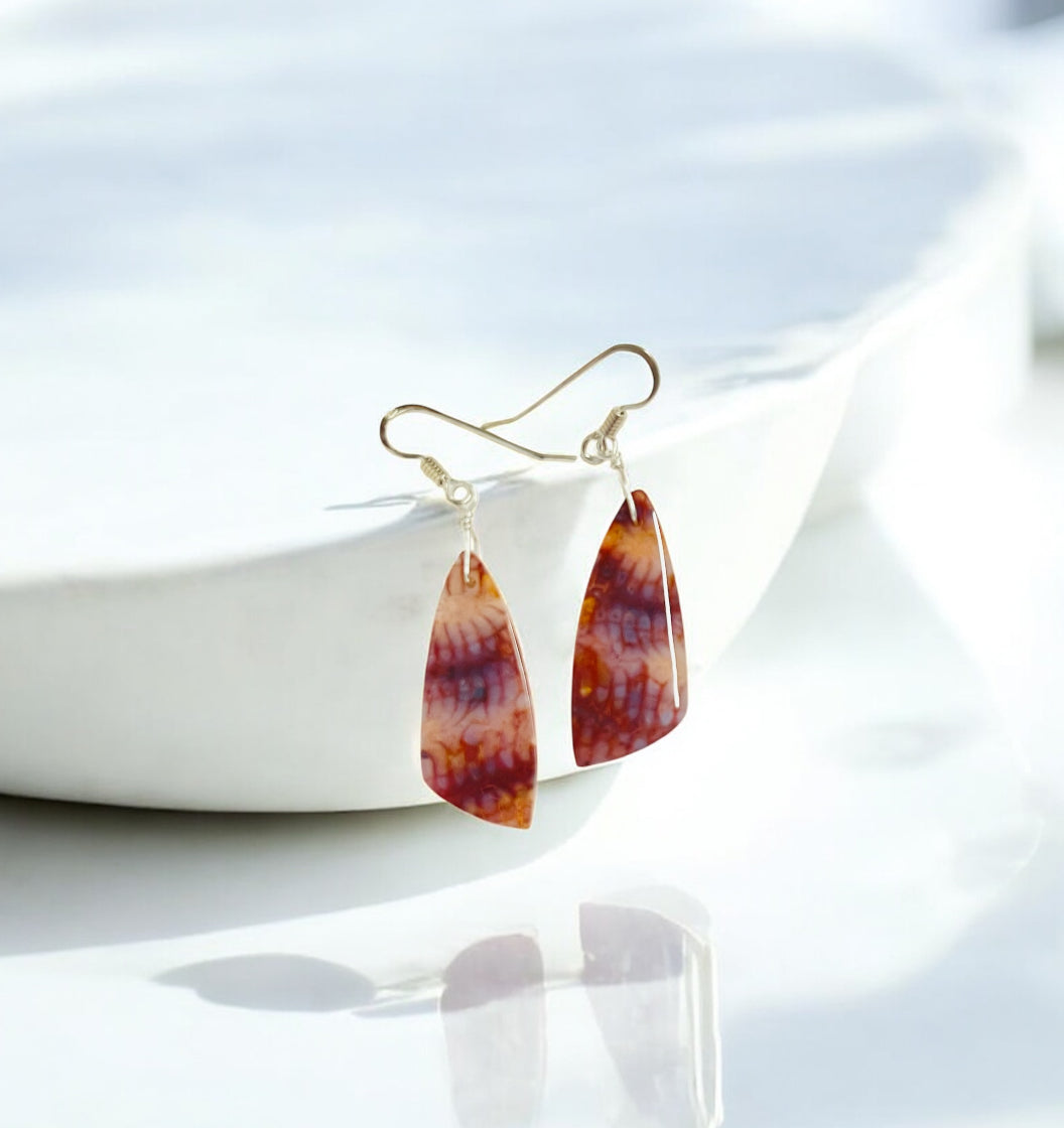 Earrings with red fossil