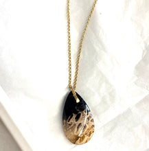 Pendant with petrified palm root