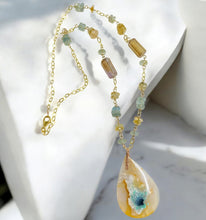 Necklace with light blue opal wood and various stones