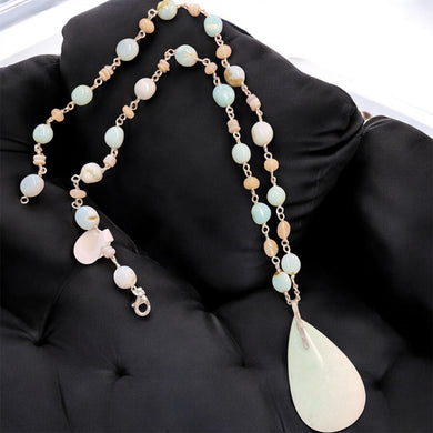 Necklace with light blue opal wood and various stones