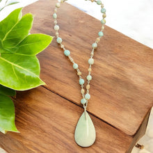 Necklace with light blue opal wood and various stones