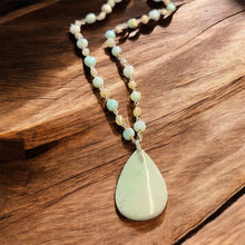 Necklace with light blue opal wood and various stones