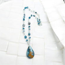 Necklace with multiple colors opalized wood in blue color symphony