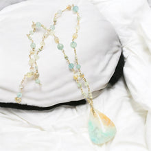 Necklace with light green and white colors opalized wood