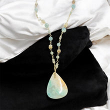 Necklace with light green and white colors opalized wood