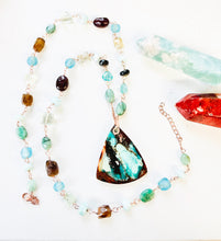 Necklace with multi color opalized wood and various gems